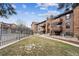 Well-maintained condo buildings with manicured lawns and walking paths in a desirable community at 203 Wright St # 102, Lakewood, CO 80228