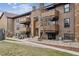 Inviting multi-story condo featuring private balconies, attractive landscaping, and a charming exterior at 203 Wright St # 102, Lakewood, CO 80228