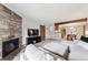 Comfortable living room features a stone fireplace and seamless flow to dining area at 203 Wright St # 102, Lakewood, CO 80228