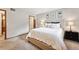 Comfortable bedroom featuring neutral tones, carpeted floors, and a large bed with a cushioned headboard at 203 Wright St # 102, Lakewood, CO 80228