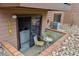 Private patio with a welcome sign, table and chairs, and sliding glass door to the living room at 203 Wright St # 102, Lakewood, CO 80228