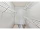 A walk-in closet with white metal shelving, offering ample storage and organization in a compact space at 203 Wright St # 102, Lakewood, CO 80228