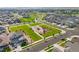 An aerial view of a vibrant community park with playground nestled among well-maintained homes at 17765 Faraday St, Broomfield, CO 80023