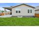 A well-maintained backyard with lawn and a small patio makes a great space for outdoor enjoyment at 17765 Faraday St, Broomfield, CO 80023