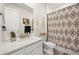 Neutral bathroom featuring patterned shower curtain, vanity, and decorative elements at 17765 Faraday St, Broomfield, CO 80023