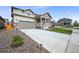 Charming two-story home with a well-manicured lawn, a wide driveway, and a welcoming front porch at 17765 Faraday St, Broomfield, CO 80023