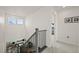 Bright hallway that looks over the lower level living room, and leads to bedrooms at 17765 Faraday St, Broomfield, CO 80023