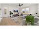 Spacious living room featuring modern decor, a large TV, and ample natural light at 17765 Faraday St, Broomfield, CO 80023