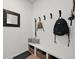 Well-organized mudroom with bench, storage baskets, hooks and plenty of space for shoes at 17765 Faraday St, Broomfield, CO 80023