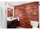 Updated bathroom with modern vanity, warm wood accent wall, and decorative starburst accents at 1260 York St # 204, Denver, CO 80206