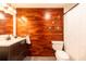 Updated bathroom with wood accent wall, modern fixtures, and combined shower/tub at 1260 York St # 204, Denver, CO 80206