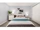 Light-filled bedroom featuring a full size bed with colorful pillows and stylish mid-century modern furniture at 1260 York St # 204, Denver, CO 80206