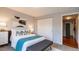 Bright bedroom featuring a bed with colorful pillows, a bench, and closet with sliding doors at 1260 York St # 204, Denver, CO 80206