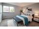 Cozy bedroom with a comfortable bed, bench, and large window for natural light at 1260 York St # 204, Denver, CO 80206