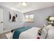 Cozy bedroom with a bed, accent pillows, a large window, and minimal modern art at 1260 York St # 204, Denver, CO 80206