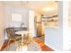 Stylish dining area featuring modern chairs, a bright white table, and views into the kitchen with stainless appliances at 1260 York St # 204, Denver, CO 80206