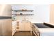 Bright kitchen with stainless steel appliances, white cabinetry, and open shelving with stylish decor at 1260 York St # 204, Denver, CO 80206
