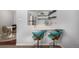 Modern kitchen bar featuring stylish teal seating, sleek white countertops, and open shelving at 1260 York St # 204, Denver, CO 80206