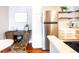 Bright kitchen area with stainless steel appliances, including refrigerator and hardwood floors at 1260 York St # 204, Denver, CO 80206