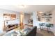 Bright living room with a cozy sectional sofa, decorative artwork, and a breakfast bar with seating at 1260 York St # 204, Denver, CO 80206