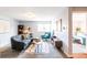 Inviting living room featuring a comfortable sofa and neutral decor with sight lines to the bedroom and kitchen at 1260 York St # 204, Denver, CO 80206