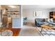 Cozy living room with stylish sofa and views into dining area with light filled kitchen and stainless steel appliances at 1260 York St # 204, Denver, CO 80206