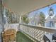 Cozy covered balcony with artificial turf, a wooden chair, and string lights at 8335 Fairmount Dr # 11-203, Denver, CO 80247