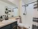 Bathroom with sleek black fixtures, white tiled shower, and a large mirror at 8335 Fairmount Dr # 11-203, Denver, CO 80247