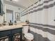 Bathroom featuring a vanity with floral accents and a stylish striped shower curtain at 8335 Fairmount Dr # 11-203, Denver, CO 80247