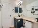 Bathroom with dark blue vanity, white doors and trim, and a large mirror at 8335 Fairmount Dr # 11-203, Denver, CO 80247