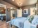 Comfortable bedroom with neutral tones, mirrored closet doors, and light hardwood flooring at 8335 Fairmount Dr # 11-203, Denver, CO 80247
