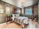 Cozy bedroom featuring paneled walls, hardwood floors, and plenty of natural light at 8335 Fairmount Dr # 11-203, Denver, CO 80247