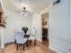 Bright dining area with a modern chandelier and view to an office nook at 8335 Fairmount Dr # 11-203, Denver, CO 80247