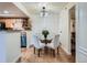 Dining area adjacent to kitchen features wood floors and modern lighting at 8335 Fairmount Dr # 11-203, Denver, CO 80247