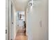 Hallway with hardwood floors leading to a kitchen and home office at 8335 Fairmount Dr # 11-203, Denver, CO 80247