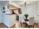 Kitchen and dining area featuring wood floors, wood cabinets, and granite counters at 8335 Fairmount Dr # 11-203, Denver, CO 80247