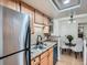 Bright kitchen with light wood cabinets, stainless steel appliances, and a dining area at 8335 Fairmount Dr # 11-203, Denver, CO 80247
