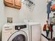 Laundry area with modern Samsung washer and dryer and storage solutions at 8335 Fairmount Dr # 11-203, Denver, CO 80247