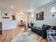 Bright living room with hardwood floors, modern decor, and a comfortable seating area at 8335 Fairmount Dr # 11-203, Denver, CO 80247