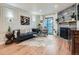 Bright living room with a stone fireplace, modern decor, and hardwood flooring at 8335 Fairmount Dr # 11-203, Denver, CO 80247