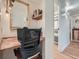 Office nook with a view to a bathroom, wood desk, and framed mirror at 8335 Fairmount Dr # 11-203, Denver, CO 80247