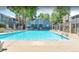 Inviting pool area with lounge chairs surrounded by mature trees and an adjacent clubhouse, perfect for relaxation at 8335 Fairmount Dr # 11-203, Denver, CO 80247