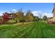 View of expansive backyard and manicured lawn featuring mature trees and landscaping at 4282 Preserve N Pkwy, Greenwood Village, CO 80121