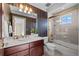 Bathroom with shower/tub combo and striped wallpaper at 4282 Preserve N Pkwy, Greenwood Village, CO 80121