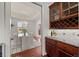 Butlers pantry with wine rack and granite countertop at 4282 Preserve N Pkwy, Greenwood Village, CO 80121