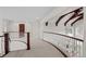 Upper hallway with curved railing and wood accents at 4282 Preserve N Pkwy, Greenwood Village, CO 80121