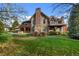 Luxury home exterior with stone and wood accents at 4282 Preserve N Pkwy, Greenwood Village, CO 80121