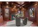 Elegant library with wood paneling, fireplace, and built-in shelving at 4282 Preserve N Pkwy, Greenwood Village, CO 80121