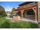 Exterior view of backyard outdoor kitchen and shaded dining patio at 4282 Preserve N Pkwy, Greenwood Village, CO 80121