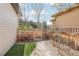 Enclosed backyard with grass, rock, stone pavers, and a wood fence at 8977 Crossington Way, Lone Tree, CO 80124